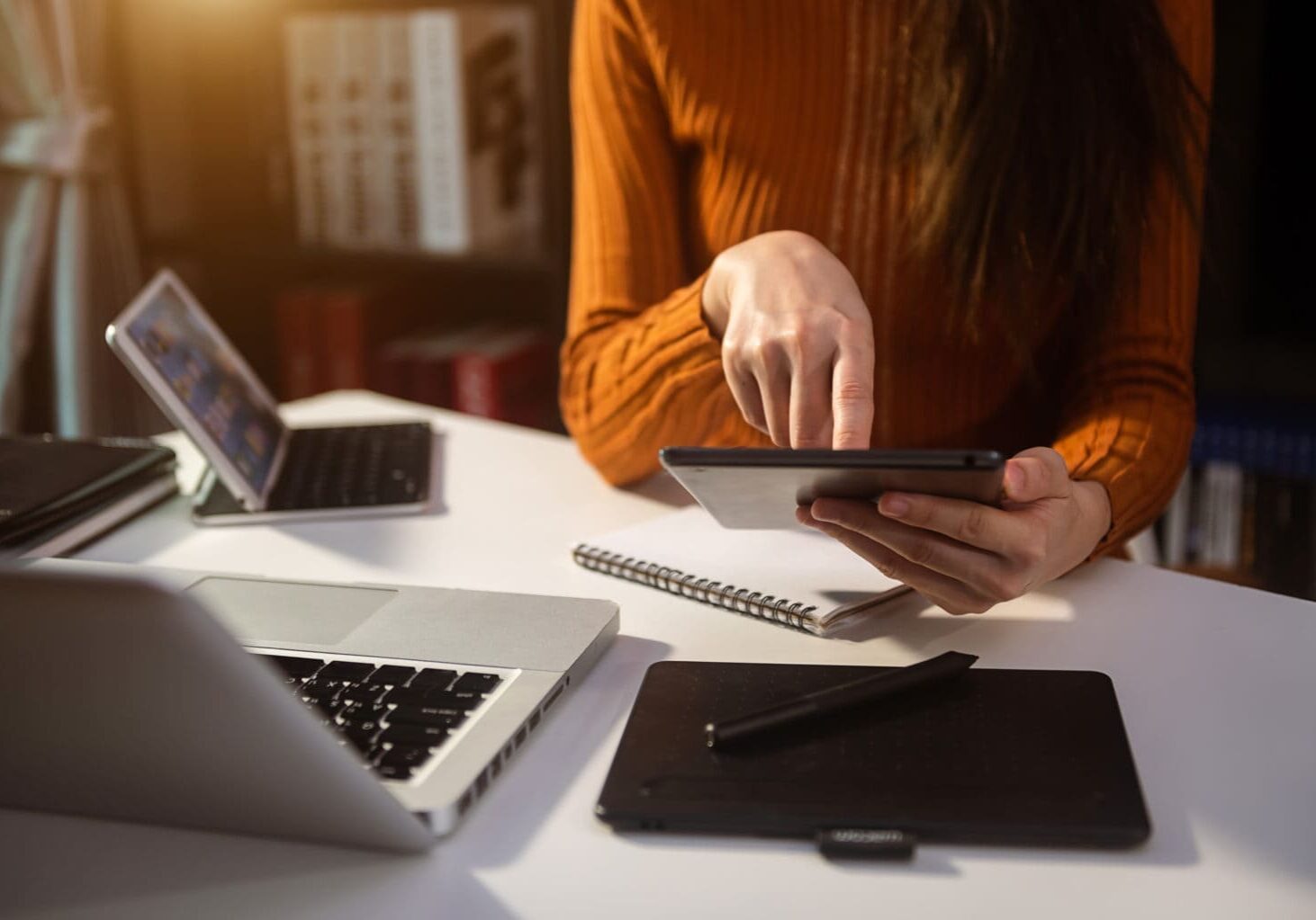 Woman using smart phone for mobile payments online shopping,omni channel,sitting on table,virtual icons graphics interface screen in morning light