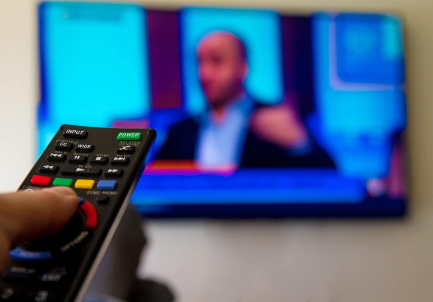 Close-up,Macro,Of,Man's,Hand,With,Tv,Remote,Control,Watching